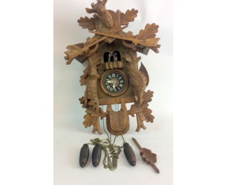 Wooden Cuckoo Clock depicting a hunting scene with deer and rifles