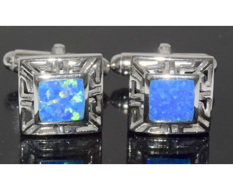 a pair of silver and blue opal cufflinks