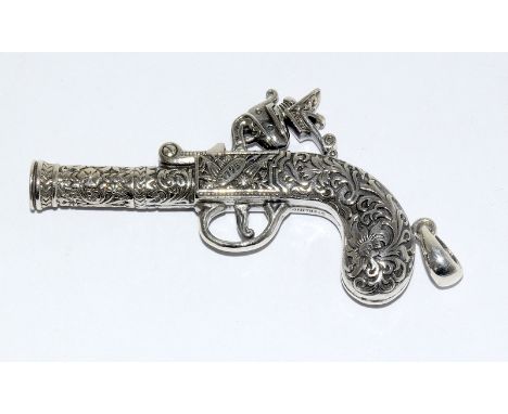 an unusual silver whistle in the form of a percushion gun