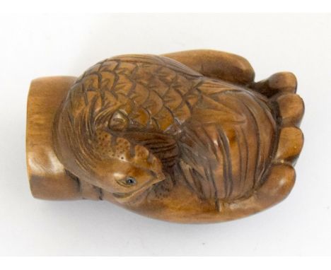 an oriental carved wooden netsuke in the form of a hand signed