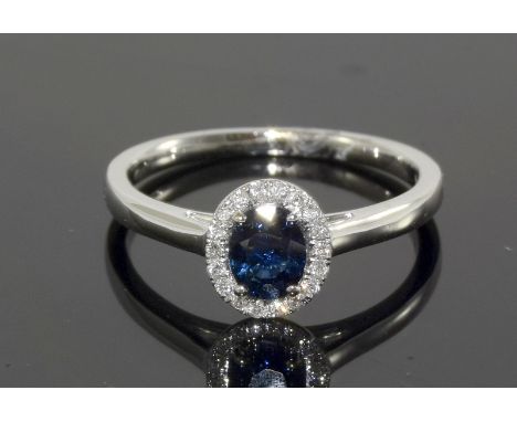 an 18ct white gold sapphire and diamond cluster ring. Size M/N