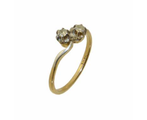 A diamond crossover ring, the brilliant cut diamond duo with scrolling shoulders, stamped 18ct, ring size P, gross weight 2.5