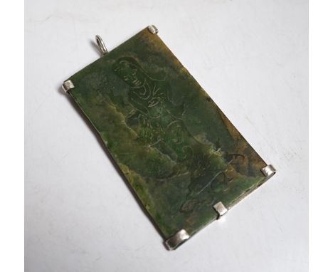 A Chinese carved spinach green jade panel,9cms high.
