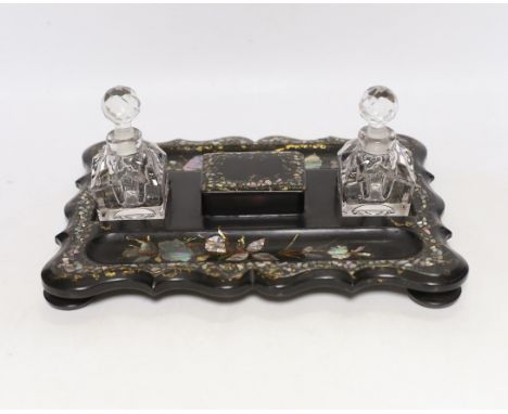 A Victorian papier mache ink stand, 26cm Good condition with some minor losses to the mother of pearl. The lid of the box has