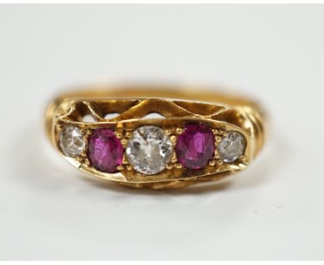 A George V 18ct gold, three stone diamond and two stone ruby set half hoop ring, size N, gross weight 3.8 grams.