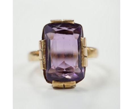 A yellow metal and single stone amethyst set dress ring, size K, gross weight 4.2 grams.