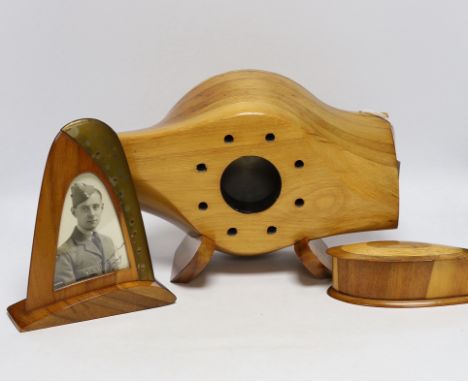 A WWII wooden propeller clock case, reputedly from a Spitfire related photo frame housing a black and white photograph of a s
