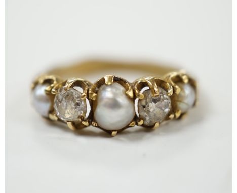 A late Victorian yellow metal and graduated three stone split pearl and two stone diamond set half hoop ring, with unusual wa