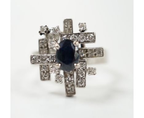 A modern 18k white metal, sapphire and diamond set modernist ring, size K/L, gross weight 6.1 grams.