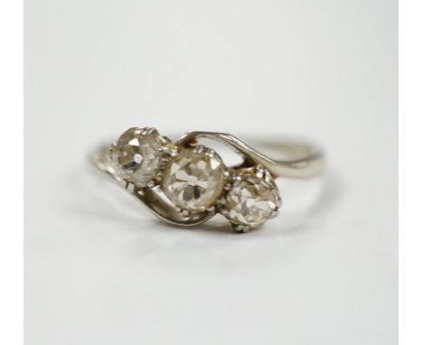 An 18ct, plat and three stone old mine cut diamond set crossover ring, size N, gross weight 2.3 grams.