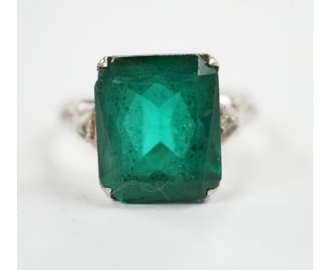 A 14k and single stone green paste set ring, with diamond chip set shoulders, size P, gross weight 3.5 grams.