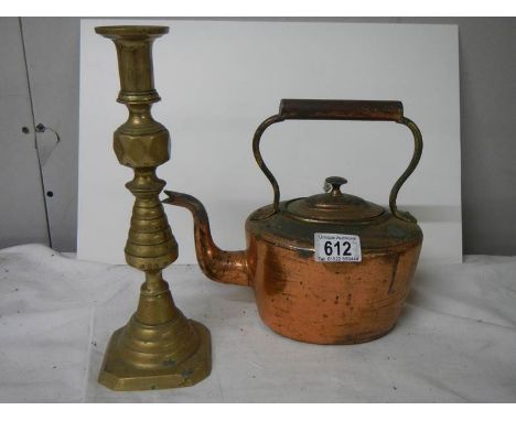 A Victorian copper kettle and a brass candlestick.