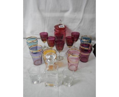 2 good sets of coloured glasses, a cranberry glass lidded jar, an etched decanter and 2 glasses.