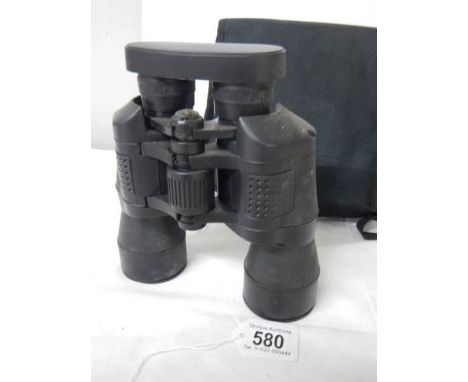 A cased pair of 7 x 50 binoculars with lens covers and fitted compass.