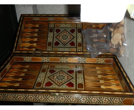 An inlaid backgammon set with pieces.