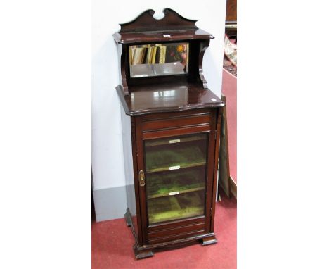 An Early XX Century Mahogany Music Cabinet, top with a swan neck pediment, upper shelf with a moulded edge, shaped supports, 