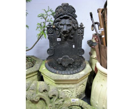 A XX Century Iron Wall Mounted Water Feature, with lions head, half round trough with gadrooned decoration.