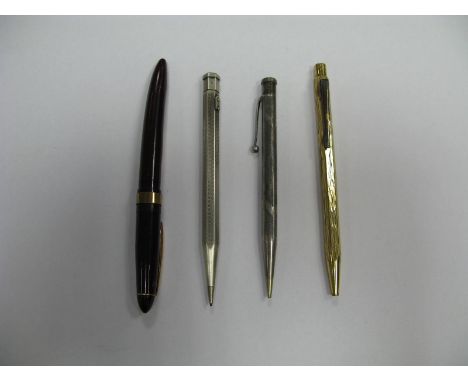 A Silver Propelling Pencil, London 1954, hexagonal form with wavy engine turned decoration; a further propelling pencil stamp