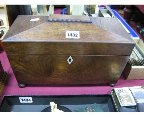 A Georgian Rosewood Tea Caddy, of sarcophagus form, on bun feet.