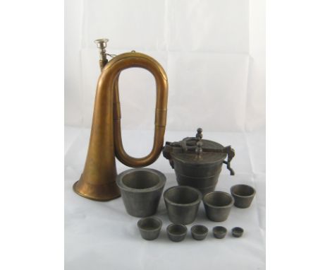 A brass bugle, together with a large set of ten alloy bucket weights, largest approx 2.2kg. 