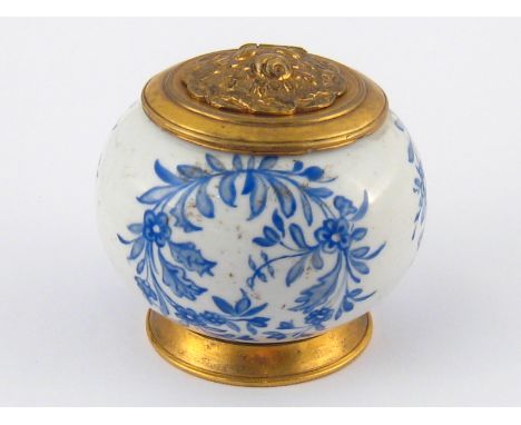 A ceramic inkwell , the white ground with blue overglaze floral panels and gilt metal lid and foot. Underglaze crossed swords