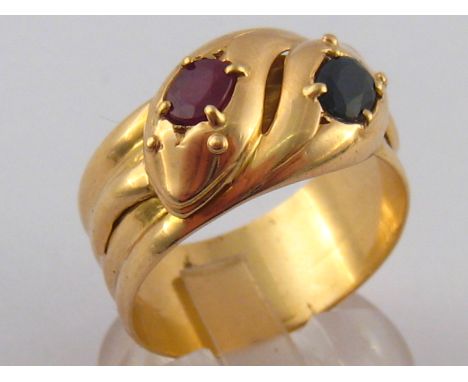 An 18 carat gold sapphire and ruby snake ring, hallmarked London 1908, 13mm wide, ring size W, 9.3 gms