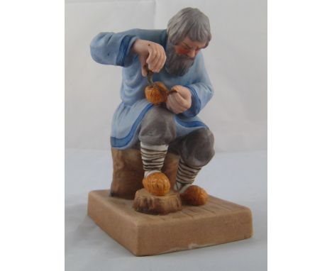 A Russian matt glazed ceramic figure of a cobbler in the manner of Gardner, unmarked. Ht.13cm. 