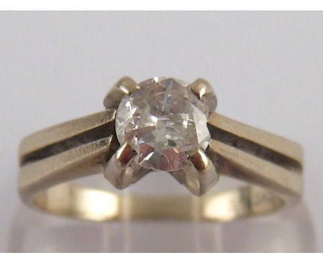 A white metal (tests 14 carat gold) diamond solitaire ring, the round brilliant cut diamond measuring approx 5.5mm diameter (