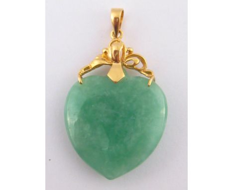 A jade heart pendant with yellow metal (tests 14 carat gold) mount, 21.5mm wide, 5.8 gms.
