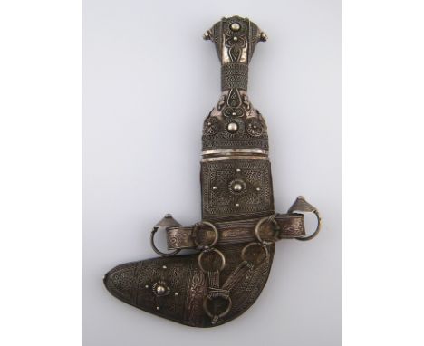 An antique “Saidi” Jambiya curved Arab dagger with silver handle and silver and leather mounted scabbard, overall approx 21cm