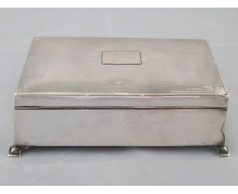A silver cigarette box with engine turned lid and slightly canted sides on four feet. Birmingham 1939, marks rubbed. 19x11x6.