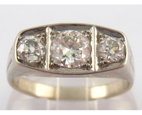 A French hallmarked 18 carat white gold and platinum three stone diamond ring, the old brilliant cut diamonds of fine colour 