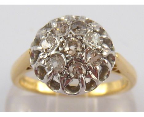 An 18 carat gold diamond cluster ring, estimated total diamond content approx 0.50 carat, ring size N, 6.2 gms.
