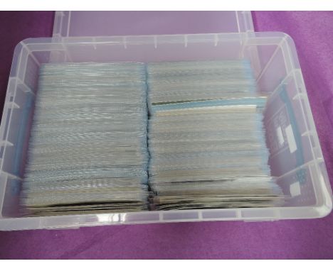 A plastic box containing approximately 600 vintage postcards in sleeves, various topics