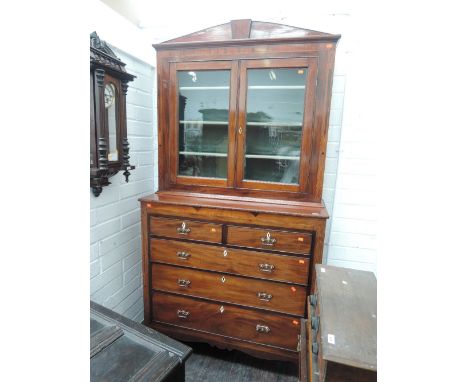 An early 19th century mahogany full height bookcase/chest having glass top section over 2 short and 3 long graduated drawers,
