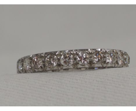 A lady's diamond set full eternity ring,  approx 1.1ct in a white metal loop, no marks possibly platinum, size P