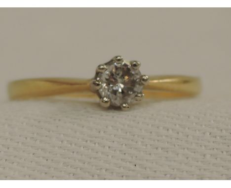 A lady's dress ring having a diamond solitaire, approx 0.25ct in a claw mount on a yellow metal loop stamped 18ct,  size L