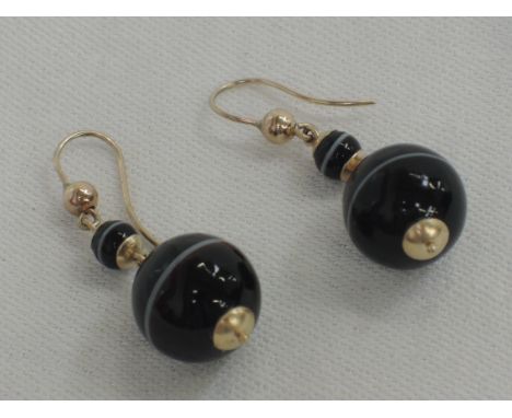 A pair of carved ring agate spherical double drop earrings on yellow metal fittings stamped 9ct