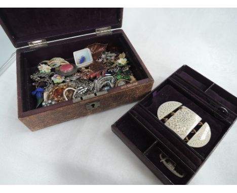 A vintage jewellery box by Boots containing a selection of costume brooches including porcelain, enamelled etc, and an enamel