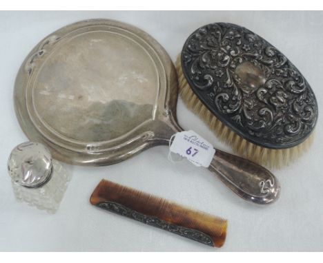 A small selection of HM silver including a hand mirror with art deco style decoration, hand brush with mask decoration, comb 