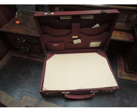 A vintage red leather London attaché case containing correspondence and writing compartments