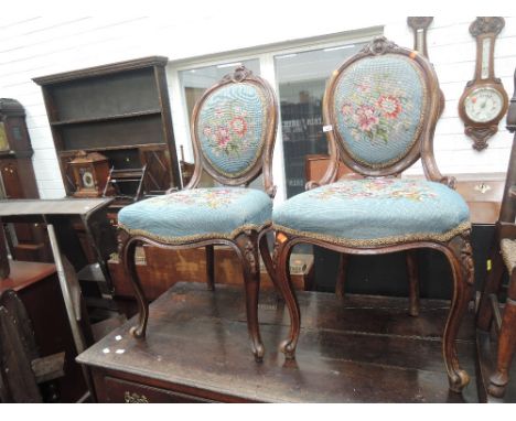 A pair of 19th century mahogany spoon back occasional chair in the French style having 20th century floral woolwork upholster