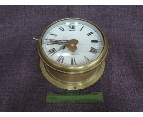 A vintage brass English circular ships bulkhead clock by Smiths, Cricklewood