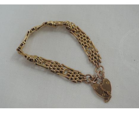 A yellow metal fancy link gate bracelet stamped 9ct having padlock clasp,  approx 12.1g 