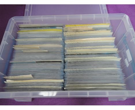 A plastic box containing approximately 600 vintage postcards in sleeves, sorted into mainly towns, villages and areas