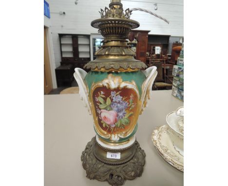 A Victorian brass and ceramic oil lamp having gilt heightened floral decoration and scroll baseGilt worn, crack to metal base