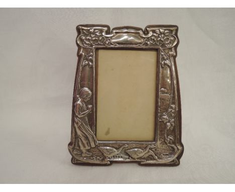 An Edwardian silver Art Nouveau design photograph frame having embossed decoration depicting a girl and geese in a countrysid