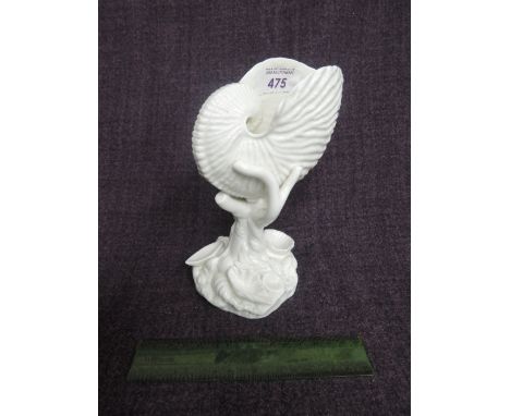 A Royal Worcester ornament modelled as a naturalistic Nautilus shell on branch and shell stem numbered 101, circa 1911