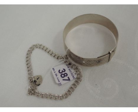 A white metal bangle stamped silver modelled as a belt with engine turned decoration and an HM silver double link curb chain 