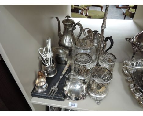 A selection of silver plate including a triple bottle stand, teapot, biscuit barrel, tea caddy etc